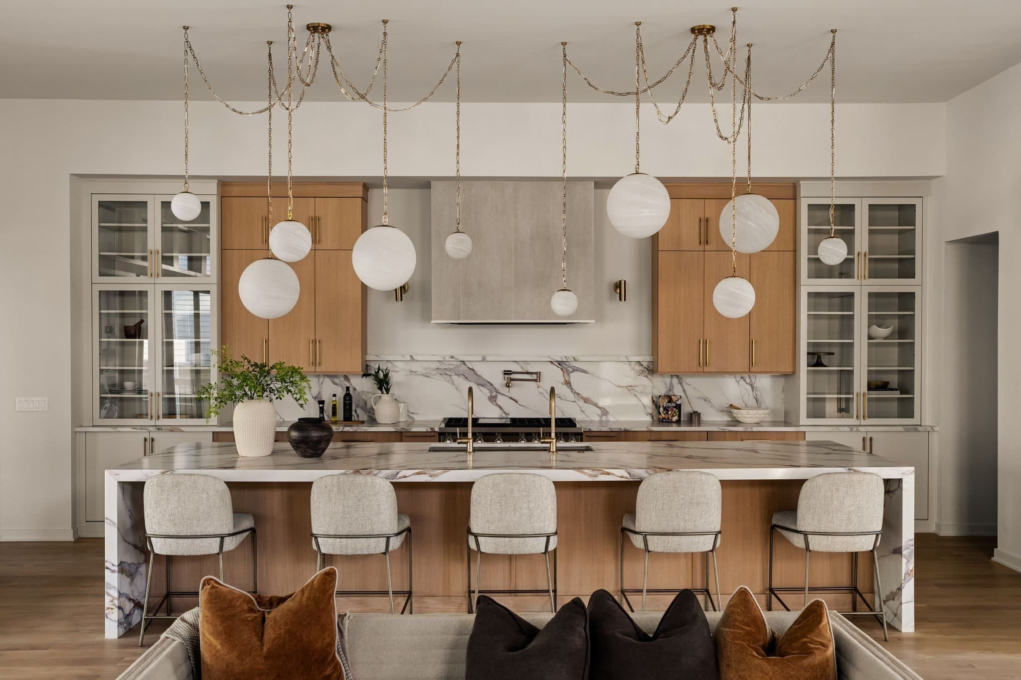 Kitchen with a long stone topped island, bar stools, and globe pendant lights at 4206B Belmont Park Terrace, Green Hills Nashville