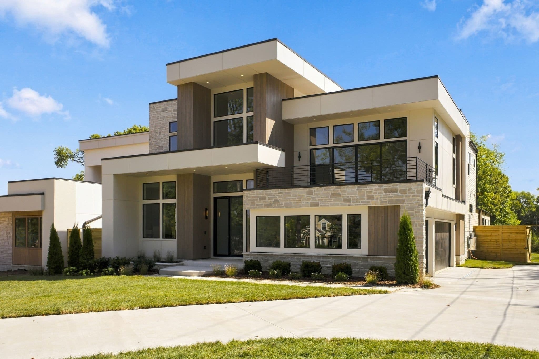 Angled view of the front of the home and its lawn on a sunny day at 4206B Belmont Park Terrace, Green Hills Nashville