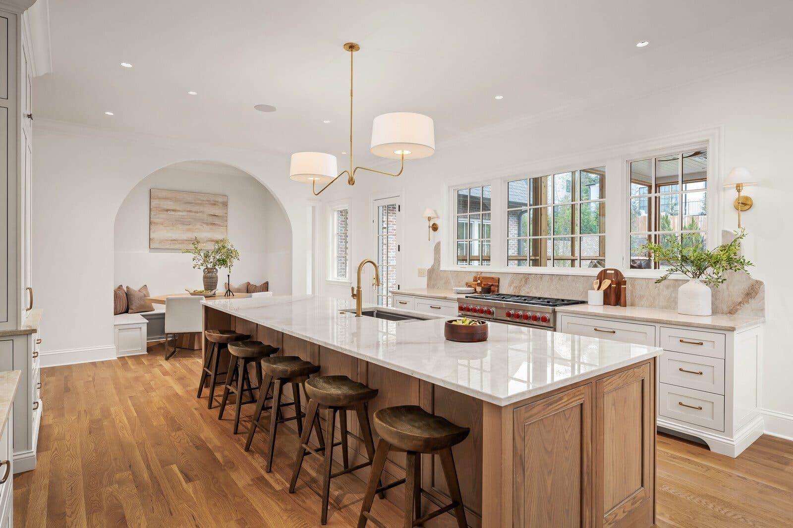 Kitchen with a long marble topped island, bar stools, and pendant lights at 1113 Glenwood Ave, Green Hills Nashville