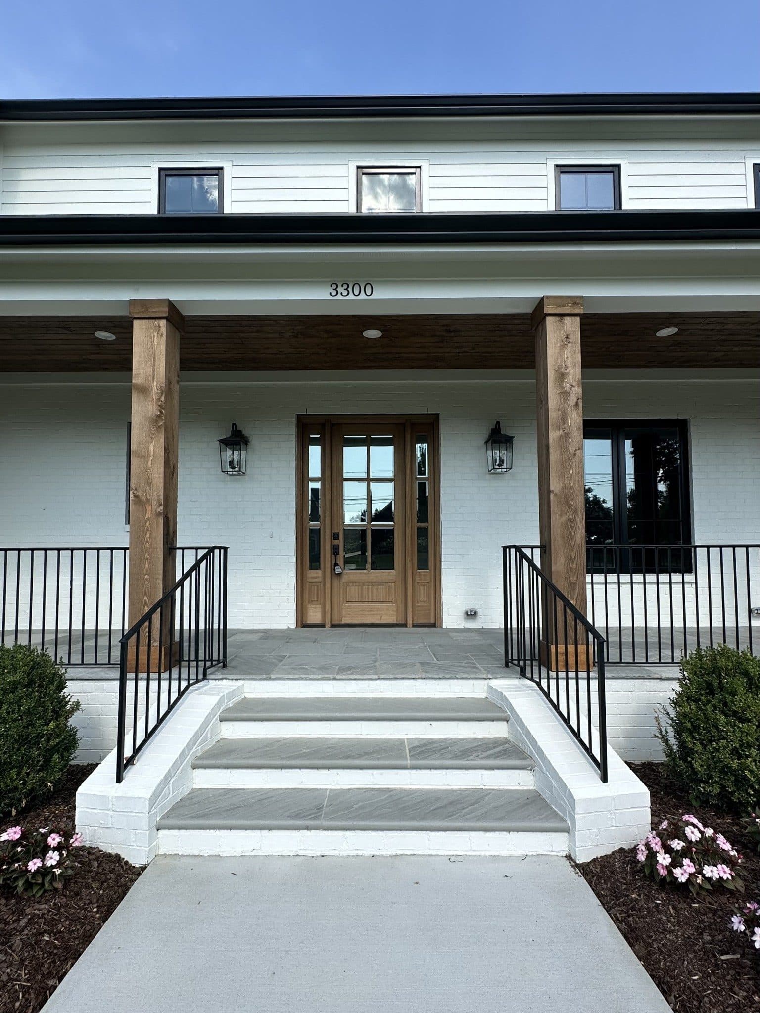 Front porch entry with wood columns, stone steps, and the house number 3300 at 3300 Trimble Road, Green Hills Nashville