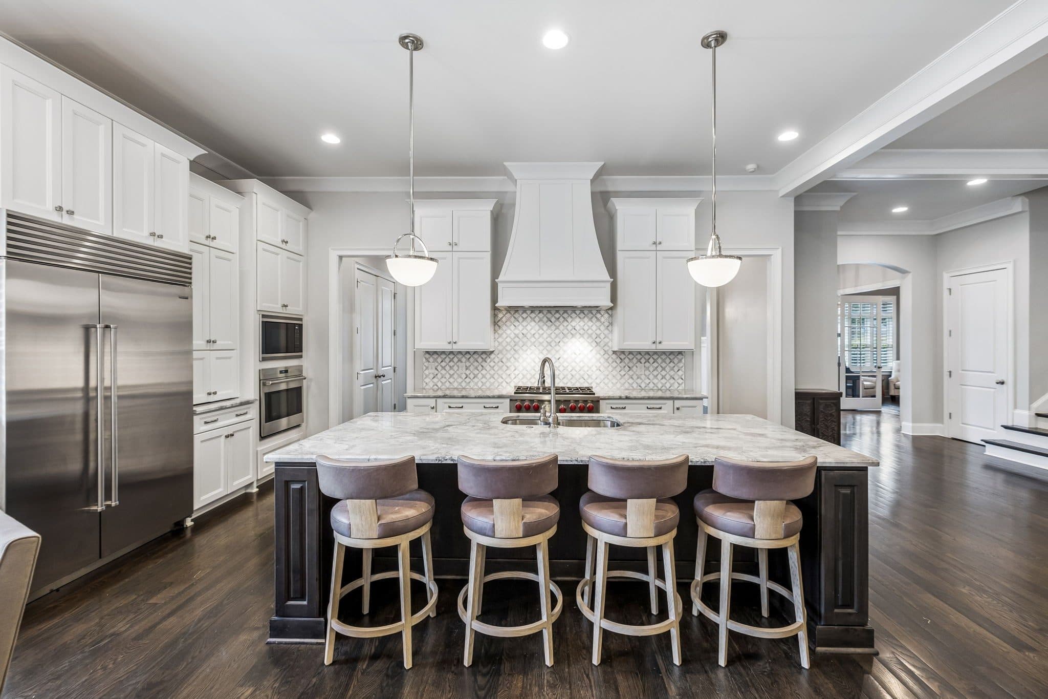 Kitchen with white cabinetry, a large dark island with bar seating, and a gas range at 4019 Vailwood Drive, Green Hills Nashville