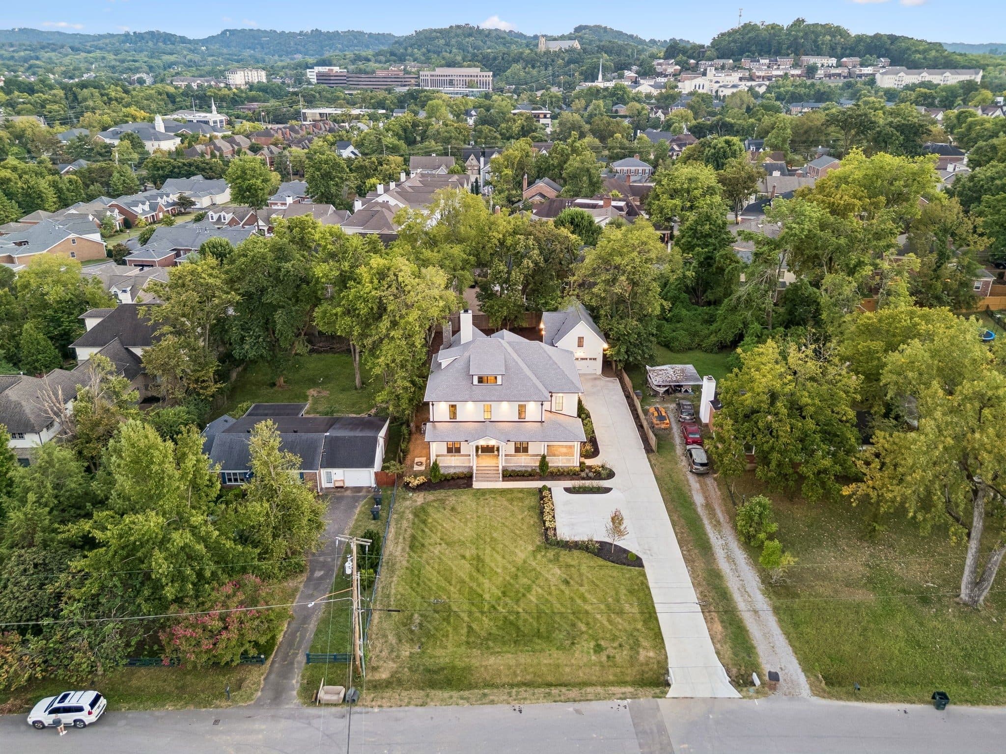 Aerial view of the home and the surrounding Green Hills streets and trees at 2301 Warfield Lane, Green Hills Nashville