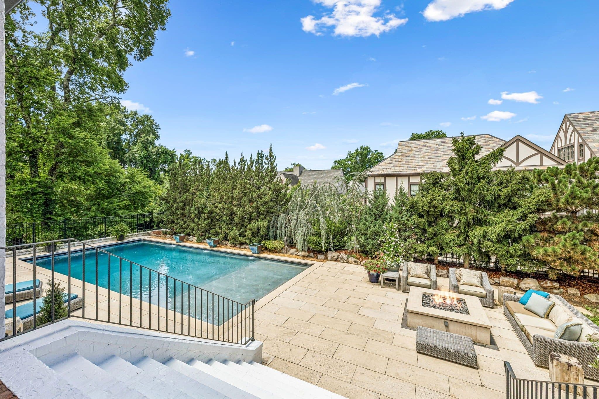 Heated pool with a stone deck and a fire pit seating area at 3719 Woodmont Boulevard, Green Hills Nashville
