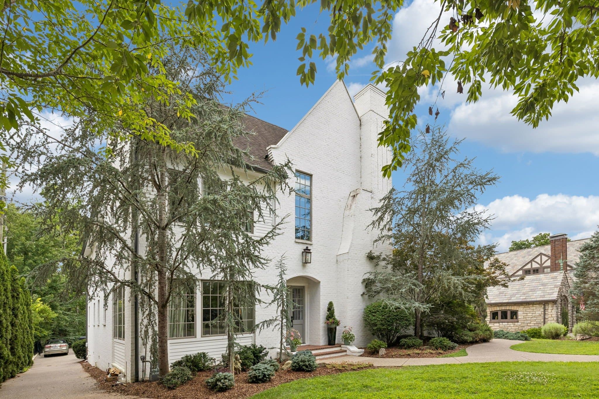 Angled front view of the white brick home and landscaping at 3719 Woodmont Boulevard, Green Hills Nashville